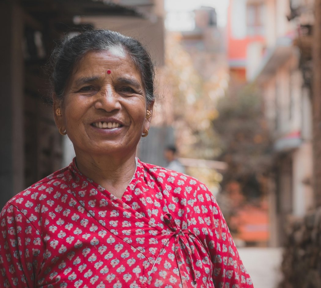 A woman smiling on a street in India